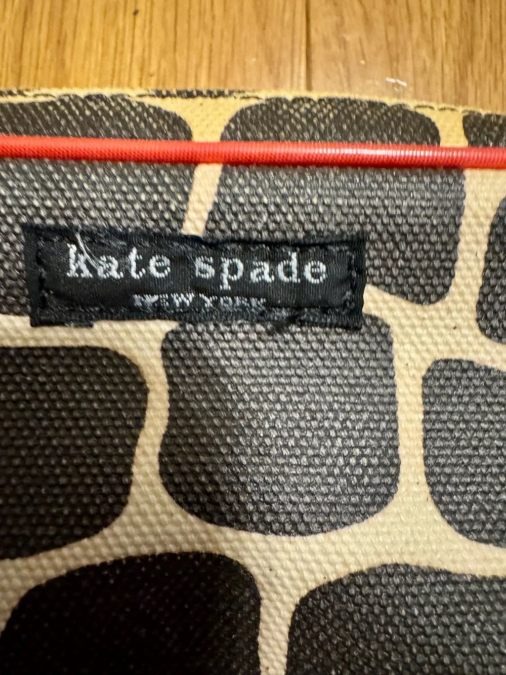 Kate Spade New York cosmetic bag or pencil case featuring a signature giraffe-